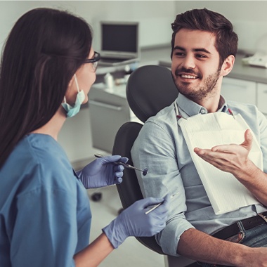 Dental patient talking to dental team member