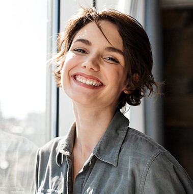 a woman smiling after dental checkup and cleaning in Avon