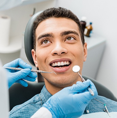 a patient smiling during a dental checkup in Avon