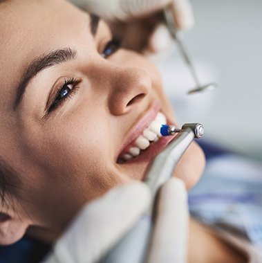 a patient smiling during a dental cleaning in Avon
