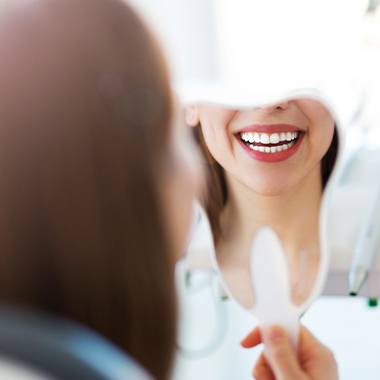 Woman looking at smile after smile makeover