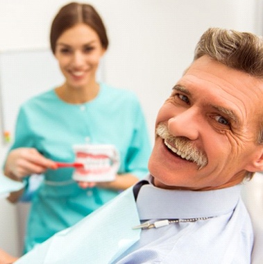 man at a consultation for dentures with his dentist in Avon