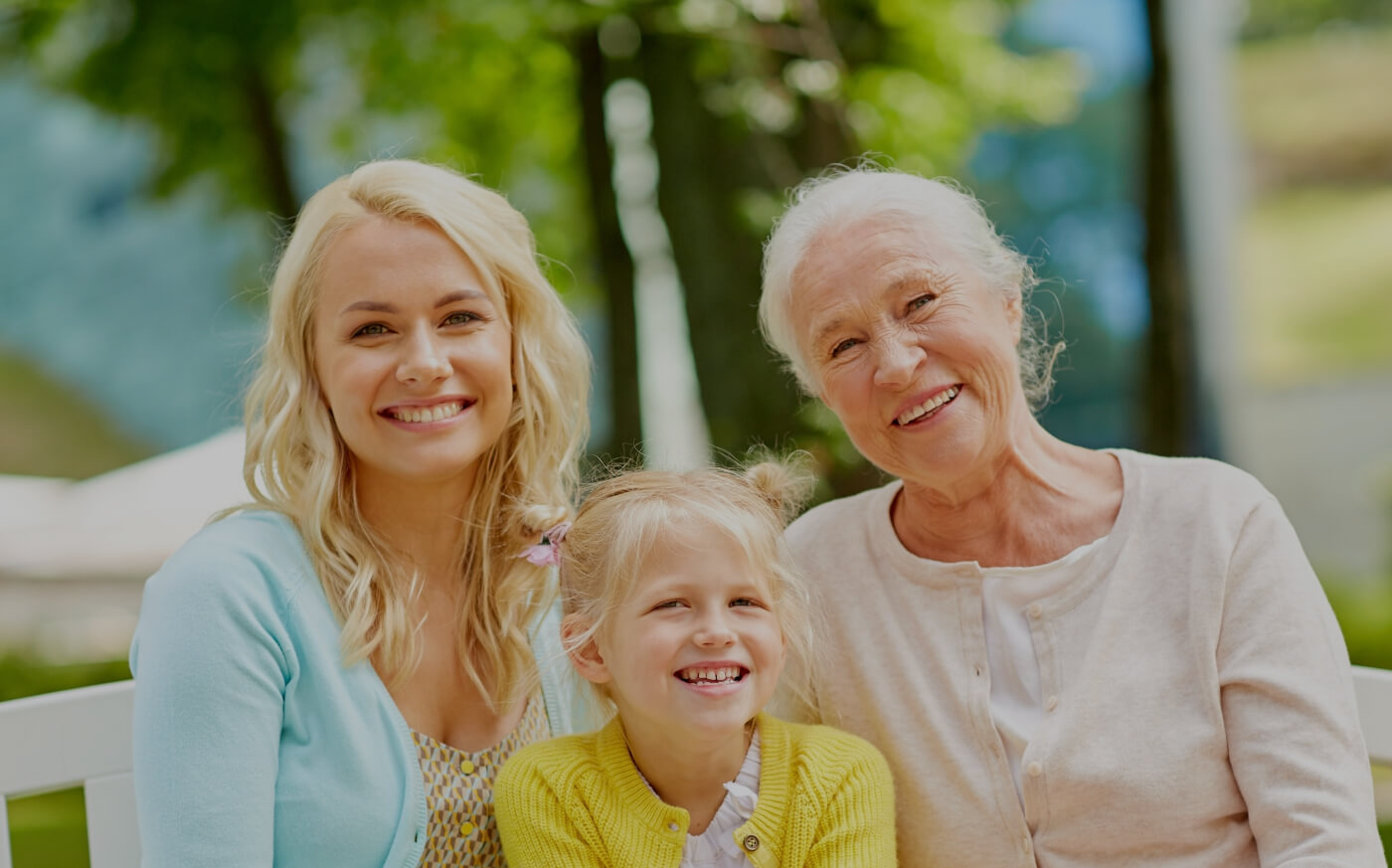 Mother daughter and granddaughter with healthy smiles after visiting Avon Dental Group