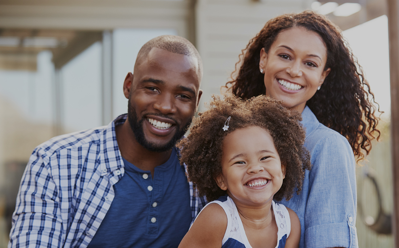 Mother father and daughter sharing smiles after family dentistry visit