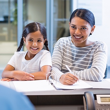 Mother and daughter checking in at dental office