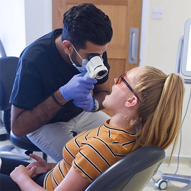 Dentist performing an oral cancer screening