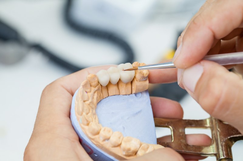 dental technician working on dental bridge