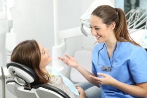 dental hygienist talking to a patient 