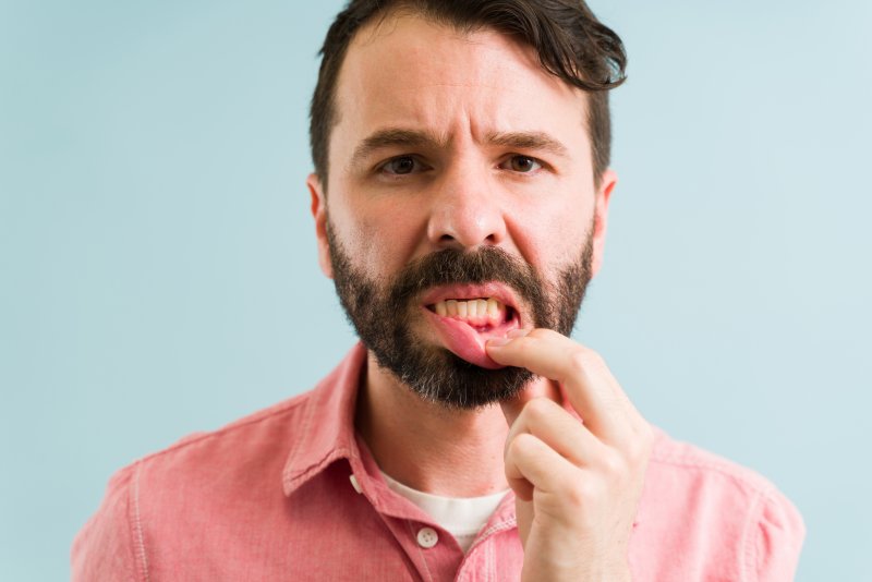 man holding open lip 